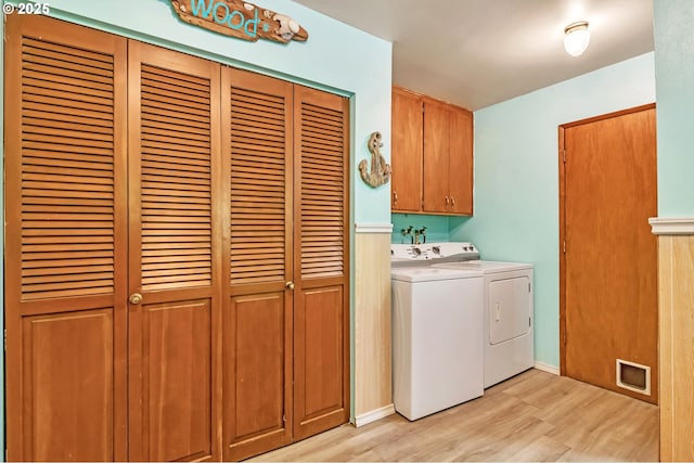 32739 Taylor Butte Rd, Cottage Grove, OR 97424 - laundry area with cabinet space, light wood finished floors, and washer and dryer