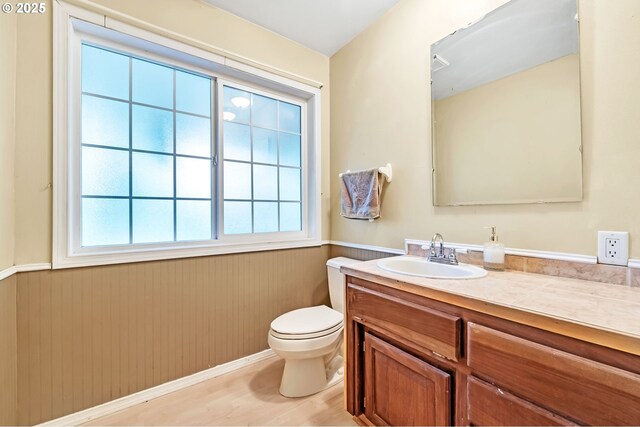 32739 Taylor Butte Rd, Cottage Grove, OR 97424 - half bath featuring a wainscoted wall, vanity, plenty of natural light, and wood finished floors