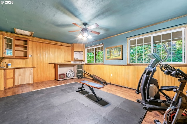 32739 Taylor Butte Rd, Cottage Grove, OR 97424 - workout area with a ceiling fan, a wainscoted wall, wood finished floors, and wood walls