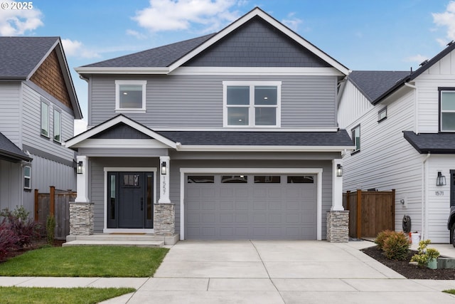 craftsman inspired home with a garage, driveway, roof with shingles, and fence