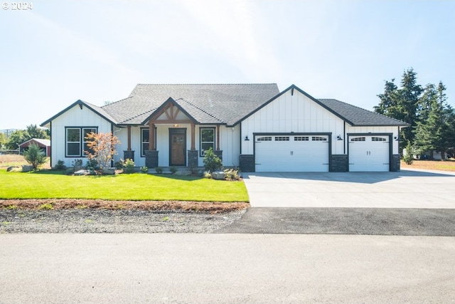 view of front of house with a front yard and a garage