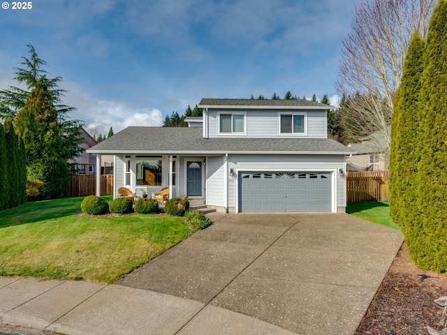 traditional-style home with a porch, concrete driveway, a front yard, fence, and a garage