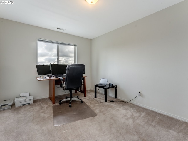 carpeted office with baseboards and visible vents