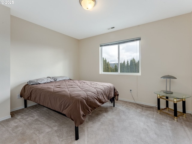 bedroom with baseboards, visible vents, and carpet flooring