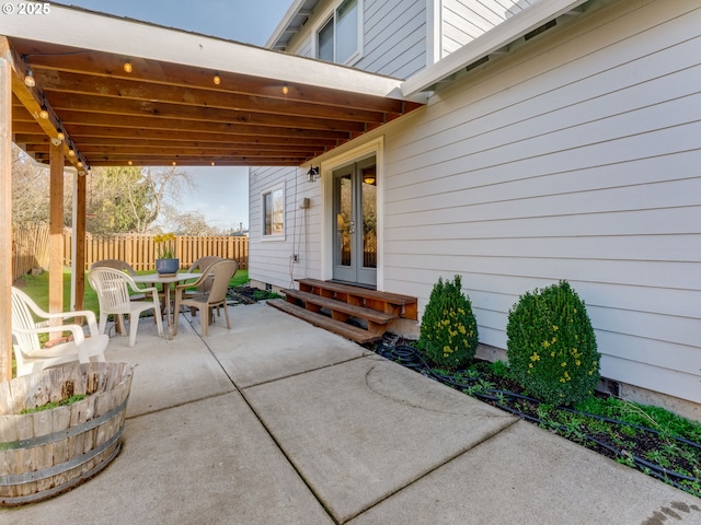 view of patio / terrace with entry steps, fence, and french doors