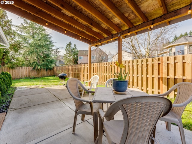 view of patio with a fenced backyard and outdoor dining area