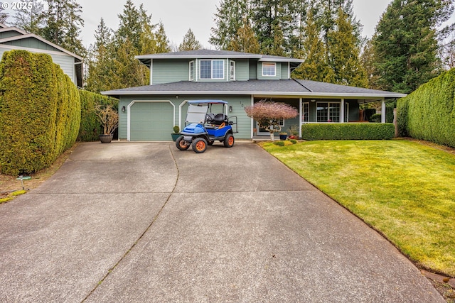 view of front of home featuring driveway, a garage, and a front lawn