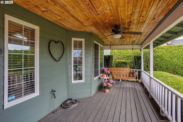 wooden deck featuring a porch and ceiling fan