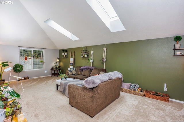 carpeted living room featuring a skylight, baseboards, and high vaulted ceiling