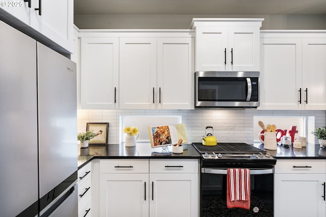 6429 SE Provence St, Hillsboro, OR 97123 - kitchen with appliances with stainless steel finishes, white cabinets, tasteful backsplash, and dark countertops