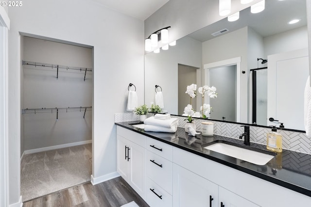 6429 SE Provence St, Hillsboro, OR 97123 - bathroom with backsplash, wood finished floors, a spacious closet, and a stall shower