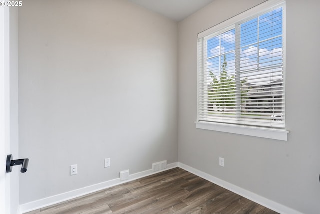 6429 SE Provence St, Hillsboro, OR 97123 - spare room with healthy amount of natural light, dark wood-style flooring, and baseboards