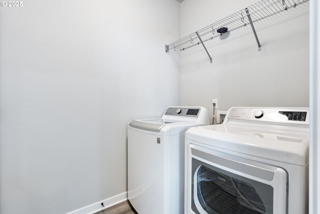 6429 SE Provence St, Hillsboro, OR 97123 - laundry room with washing machine and clothes dryer, baseboards, and wood finished floors