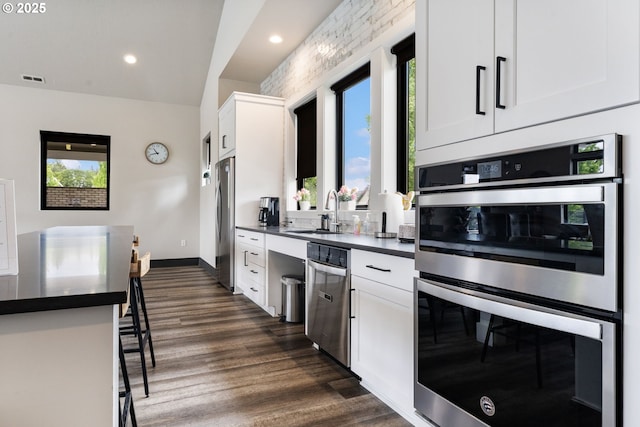 6429 SE Provence St, Hillsboro, OR 97123 - kitchen with a sink, stainless steel appliances, dark countertops, plenty of natural light, and recessed lighting