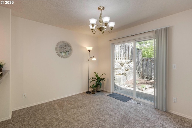 doorway with a chandelier, carpet floors, baseboards, and a textured ceiling