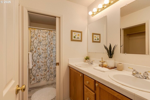 bathroom with double vanity and a shower with shower curtain