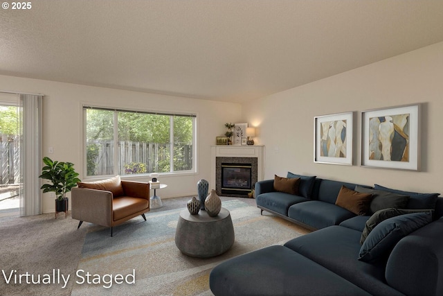 carpeted living area featuring healthy amount of natural light and a fireplace