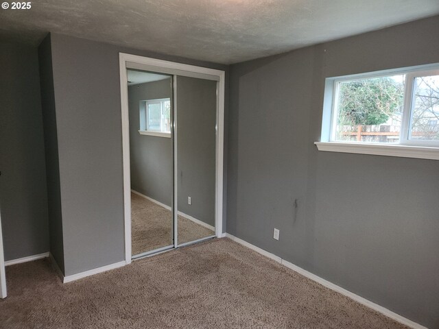 82284 Hillview Dr, Creswell, OR 97426 - unfurnished bedroom featuring baseboards, a closet, carpet, and a textured ceiling