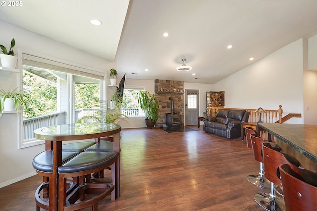40920 NW Maple Ridge Rd, Woodland, WA 98674 - dining room featuring a wood stove, lofted ceiling, dark wood-type flooring, and recessed lighting
