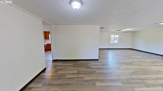 132 NE Rifle Range St, Roseburg, OR 97470 - empty room featuring a textured ceiling, wood finished floors, and baseboards