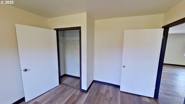 132 NE Rifle Range St, Roseburg, OR 97470 - unfurnished bedroom with wood finished floors, baseboards, and a closet