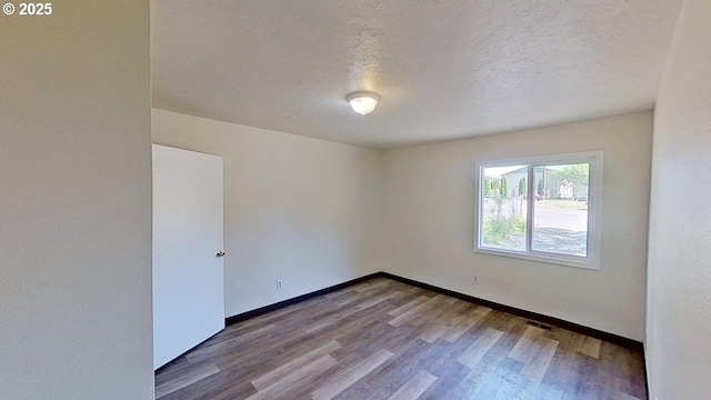 132 NE Rifle Range St, Roseburg, OR 97470 - spare room featuring wood finished floors, a textured ceiling, and baseboards