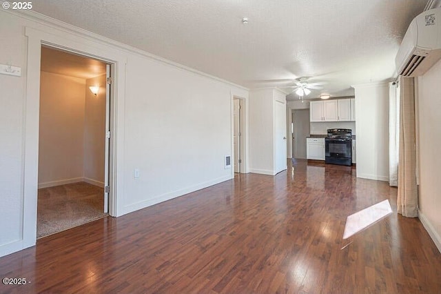 unfurnished living room featuring a wall mounted AC, ceiling fan, dark wood-style flooring, crown molding, and baseboards