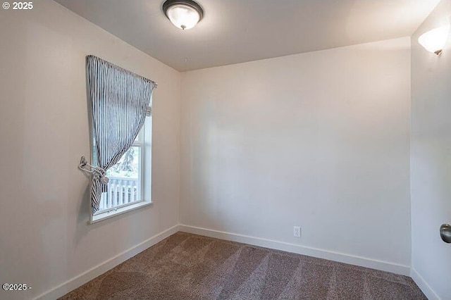 carpeted spare room with baseboards