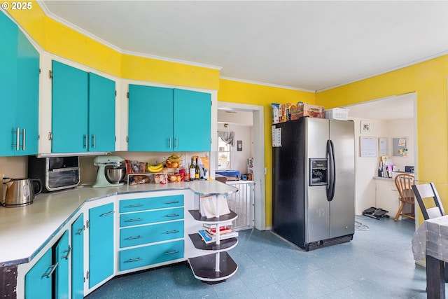 kitchen with crown molding, blue cabinetry, light countertops, stainless steel fridge with ice dispenser, and tile patterned floors