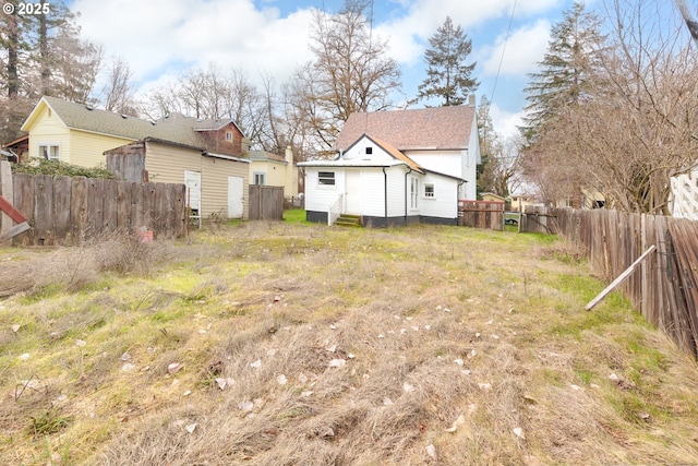 view of yard with entry steps and fence