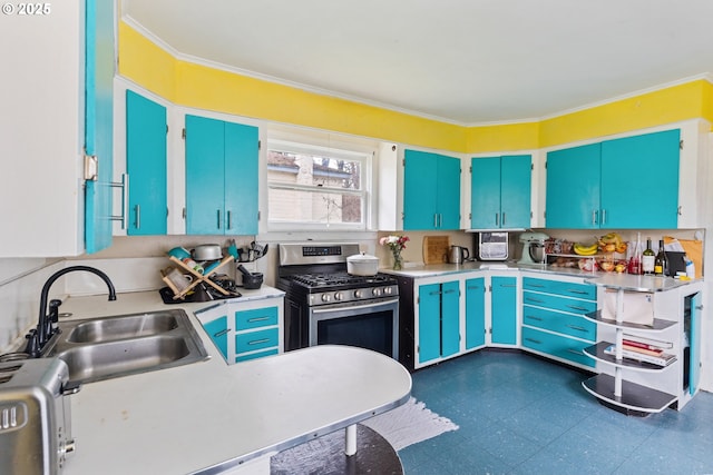 kitchen featuring light countertops, a sink, stainless steel range with gas stovetop, and crown molding