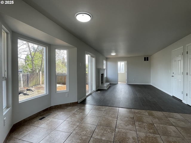 5145 Trevon St, Eugene, OR 97402 - unfurnished living room with a fireplace and dark tile patterned flooring