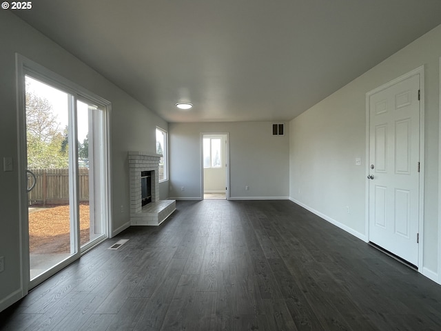 5145 Trevon St, Eugene, OR 97402 - unfurnished living room featuring dark wood-style flooring and a brick fireplace