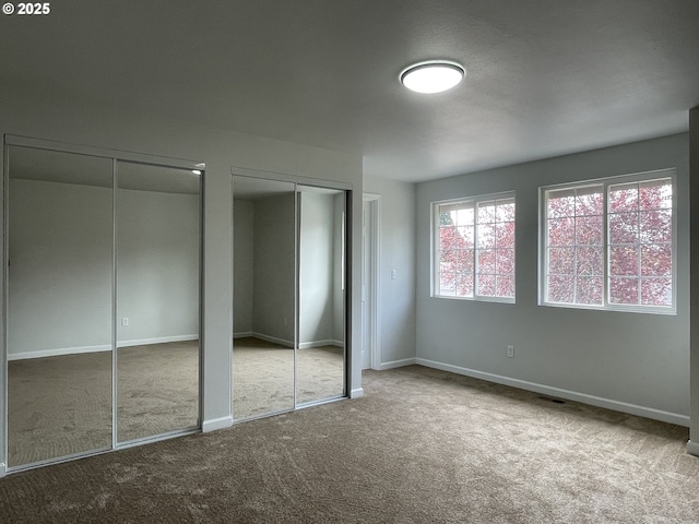 5145 Trevon St, Eugene, OR 97402 - unfurnished bedroom with multiple closets and carpet flooring