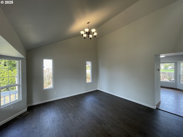 5145 Trevon St, Eugene, OR 97402 - unfurnished room featuring a chandelier, dark wood-type flooring, healthy amount of natural light, and high vaulted ceiling