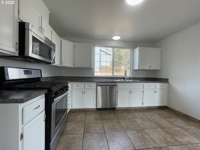 5145 Trevon St, Eugene, OR 97402 - kitchen featuring appliances with stainless steel finishes, dark countertops, and white cabinets