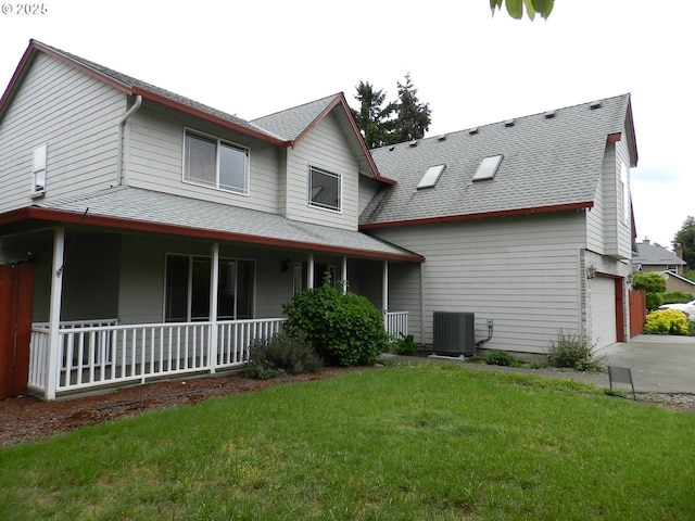 31811 NW Belgium Ct, North Plains, OR 97133 - rear view of property featuring covered porch, a shingled roof, a yard, concrete driveway, and a garage