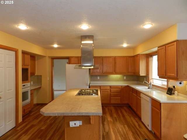 31811 NW Belgium Ct, North Plains, OR 97133 - kitchen featuring white appliances, extractor fan, dark wood-type flooring, light countertops, and recessed lighting