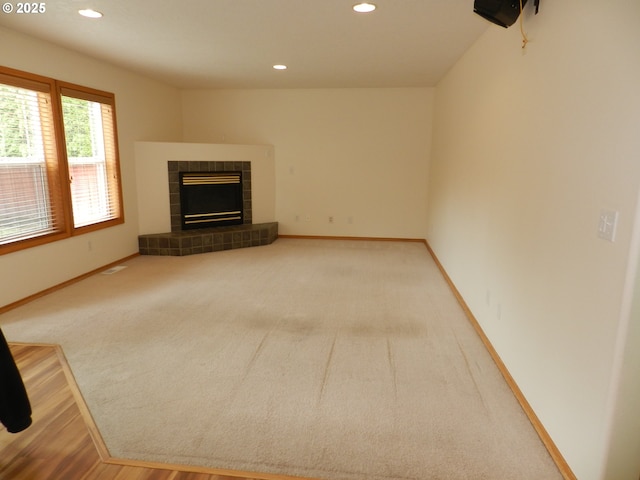 31811 NW Belgium Ct, North Plains, OR 97133 - unfurnished living room with recessed lighting, a tiled fireplace, and carpet