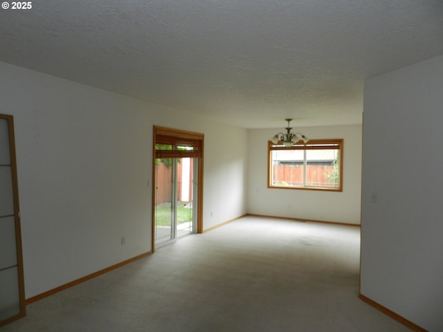31811 NW Belgium Ct, North Plains, OR 97133 - spare room with a chandelier, light colored carpet, and a textured ceiling