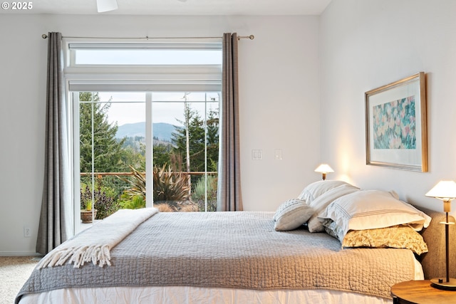 bedroom featuring carpet and a mountain view