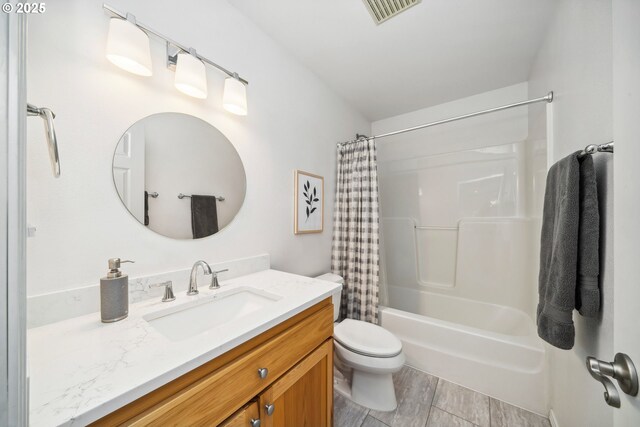 bathroom featuring shower / bath combination with curtain, visible vents, toilet, and vanity