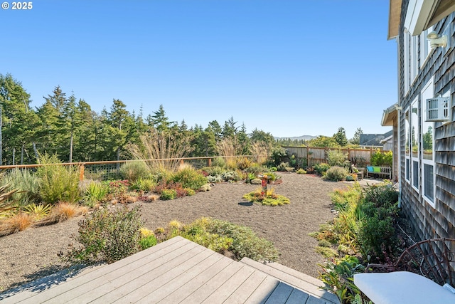 view of yard with a fenced backyard and a wooden deck