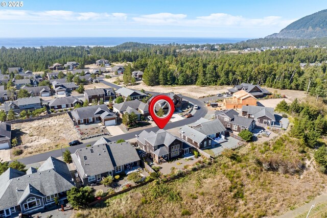 bird's eye view featuring a wooded view and a residential view