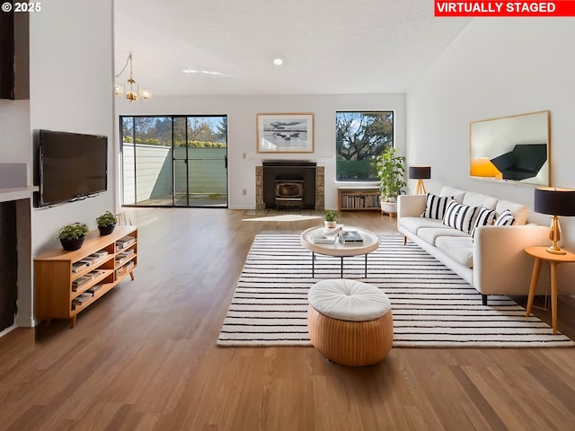 living room with a notable chandelier, recessed lighting, and wood finished floors