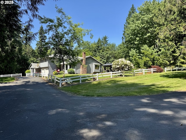 24035 SW Mountain Creek Rd, Sherwood, OR 97140 - view of property hidden behind natural elements featuring asphalt driveway, a chimney, and a garage