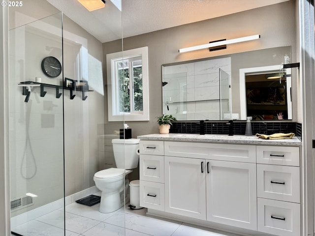 24035 SW Mountain Creek Rd, Sherwood, OR 97140 - full bath with toilet, vanity, walk in shower, tasteful backsplash, and marble look tiles