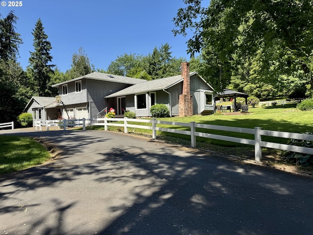 24035 SW Mountain Creek Rd, Sherwood, OR 97140 - tri-level home with driveway, a chimney, and an attached garage