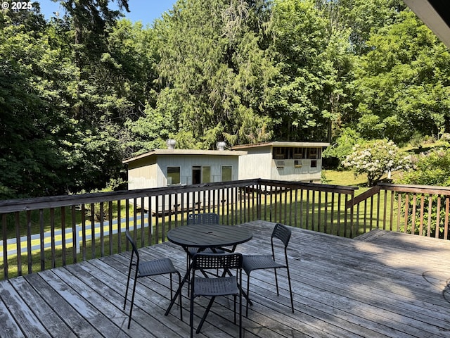 24035 SW Mountain Creek Rd, Sherwood, OR 97140 - wooden terrace with outdoor dining area, a lawn, and an outdoor structure