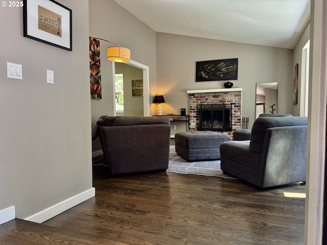 24035 SW Mountain Creek Rd, Sherwood, OR 97140 - living room featuring vaulted ceiling, dark wood-type flooring, a fireplace, and baseboards